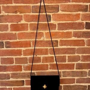 Black vintage velvet shoulder bag with gold hardware, featuring a large clasp